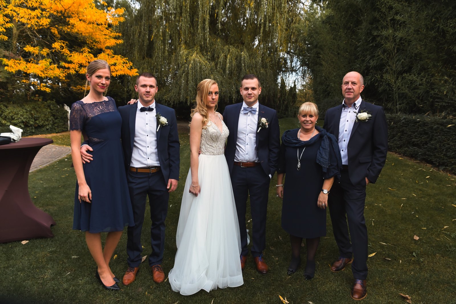 private wedding party with groom in blue and bride in white and cowgirl