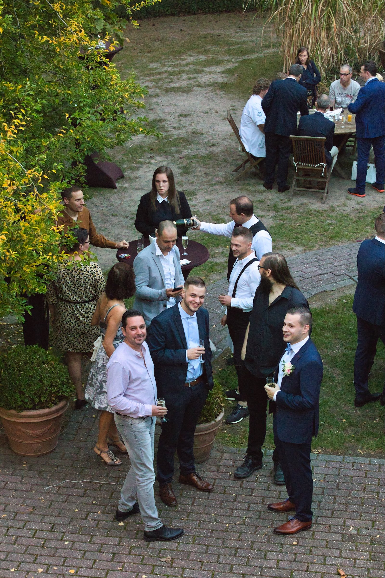 private wedding party with groom in blue and bride in white and cowgirl