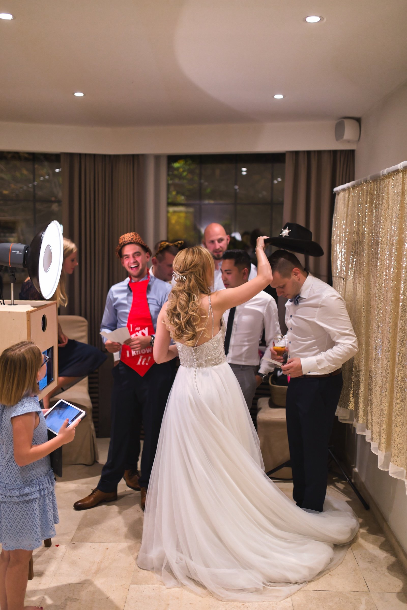 private wedding party with groom in blue and bride in white and cowgirl